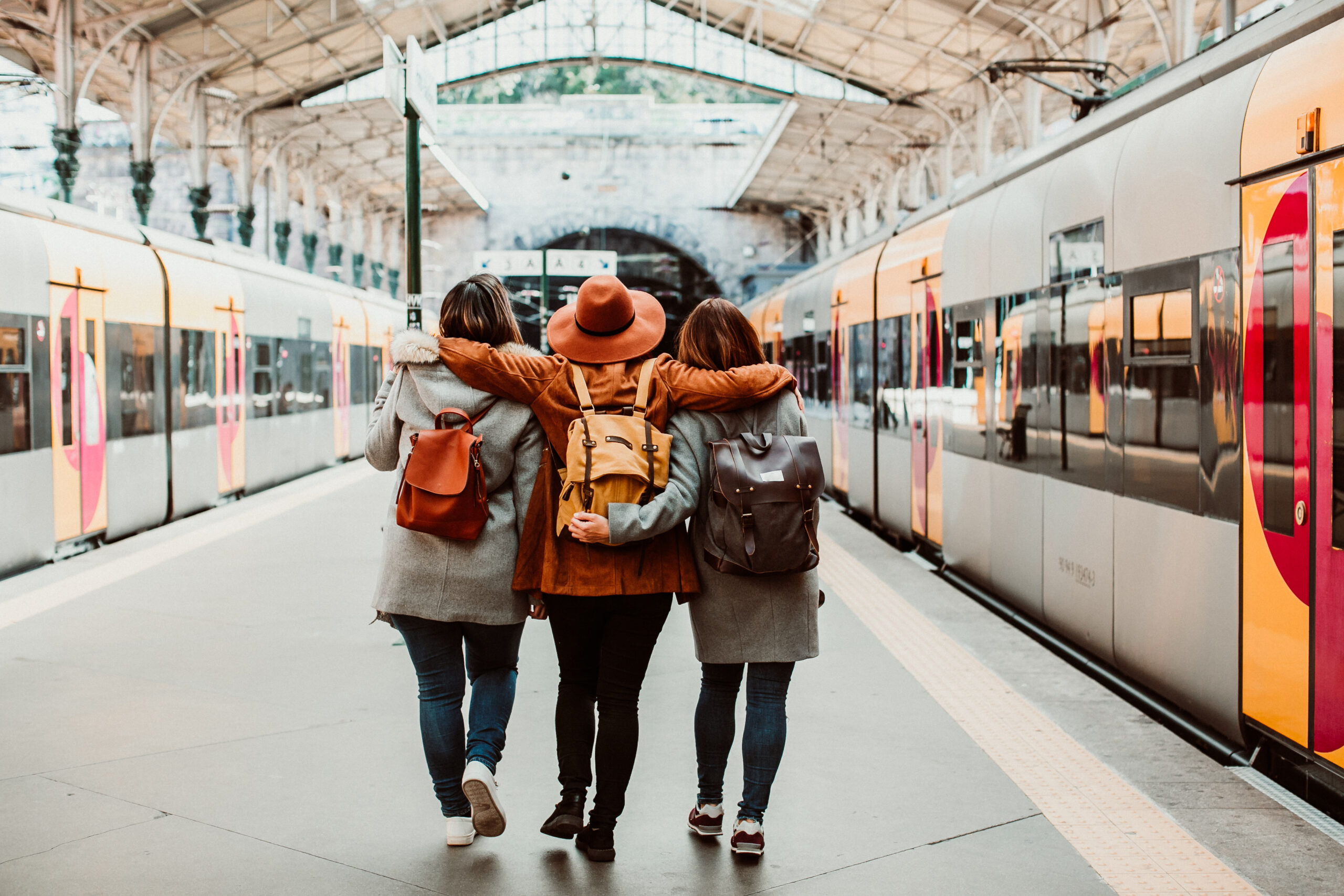 A group of young friends waiting relaxed and carefree at the station in Porto, Portugal before catching a train. Travel photography. Lifestyle.
